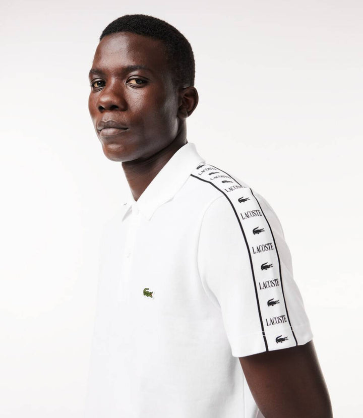 Polo Lacoste à bande grifféé blanc